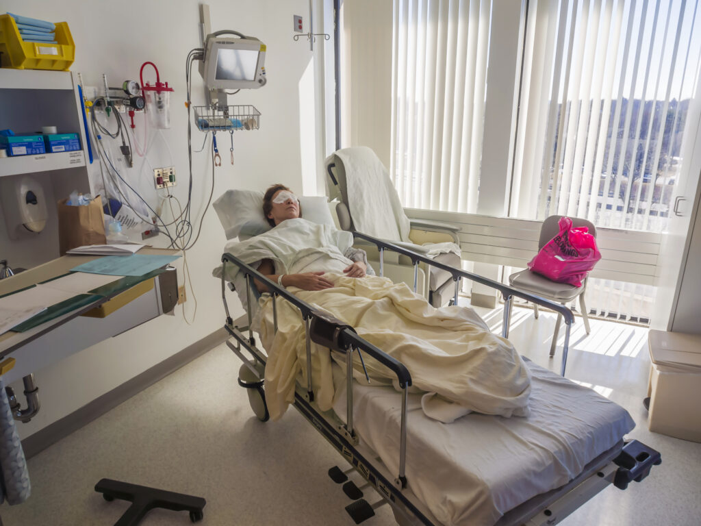 Hospital room with patient who is recovering from LASIK eye operation