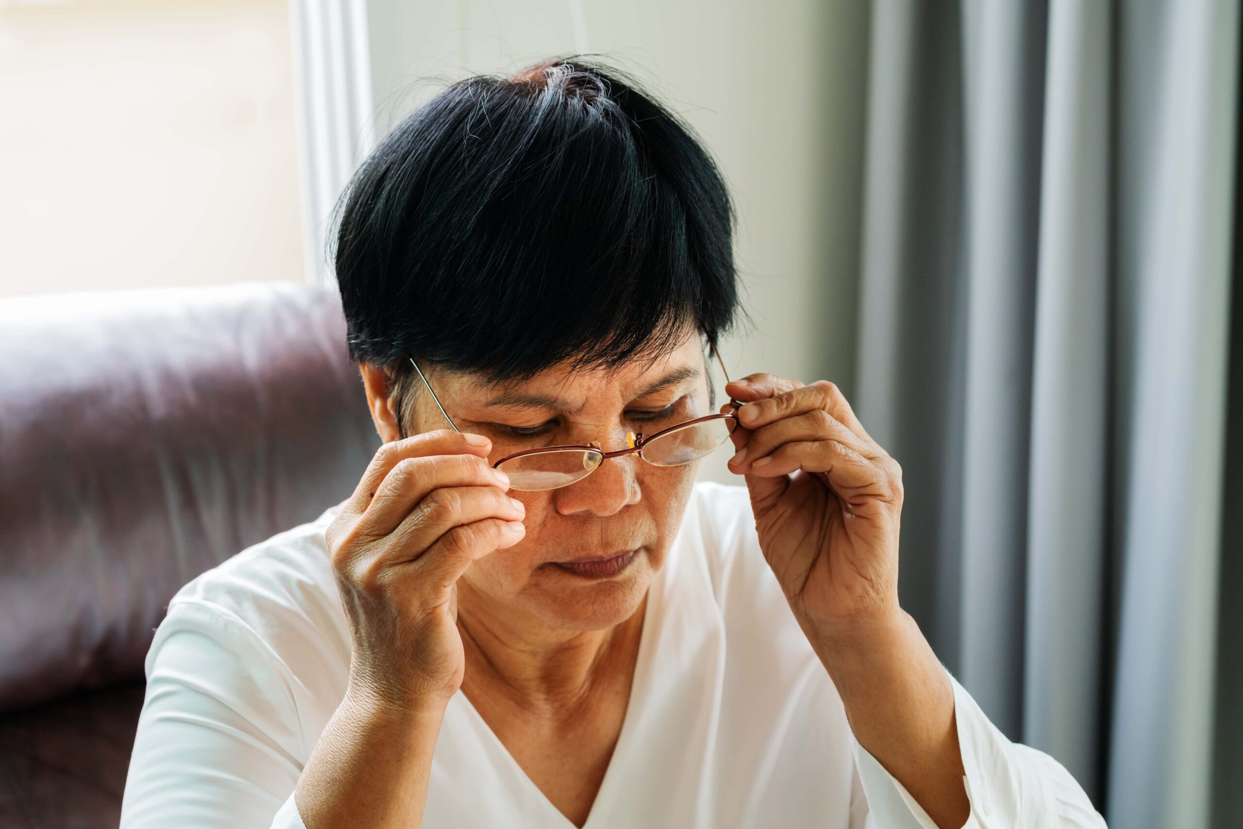 mature asian woman wearing her eyeglasses edited scaled