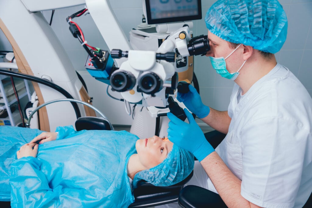 Patient under surgical microscope for vision correction