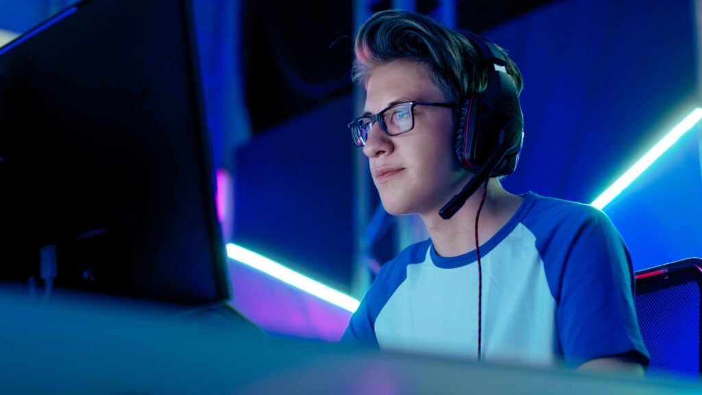 Teenage Boy Gamer Plays in Competitive Video Game on an egames competition